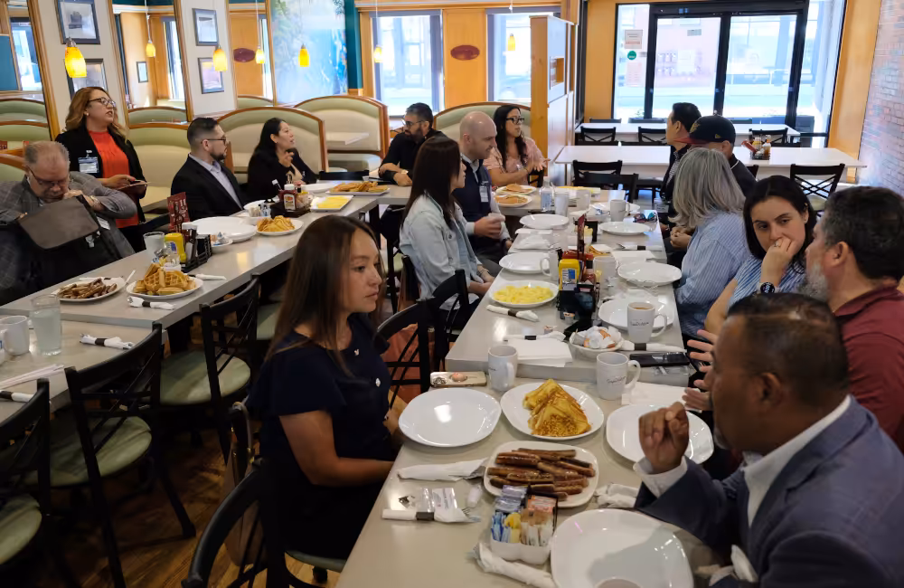 First arrivals enjoy networking and family-style dining at the business breakfast on June 23, 2026.