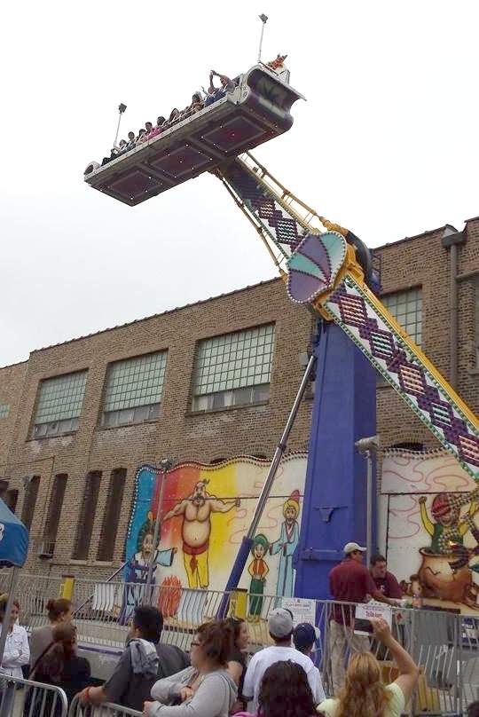 Blessed Sacrament Parish carnival attendees wait for the pendulum ride at a past carnival.