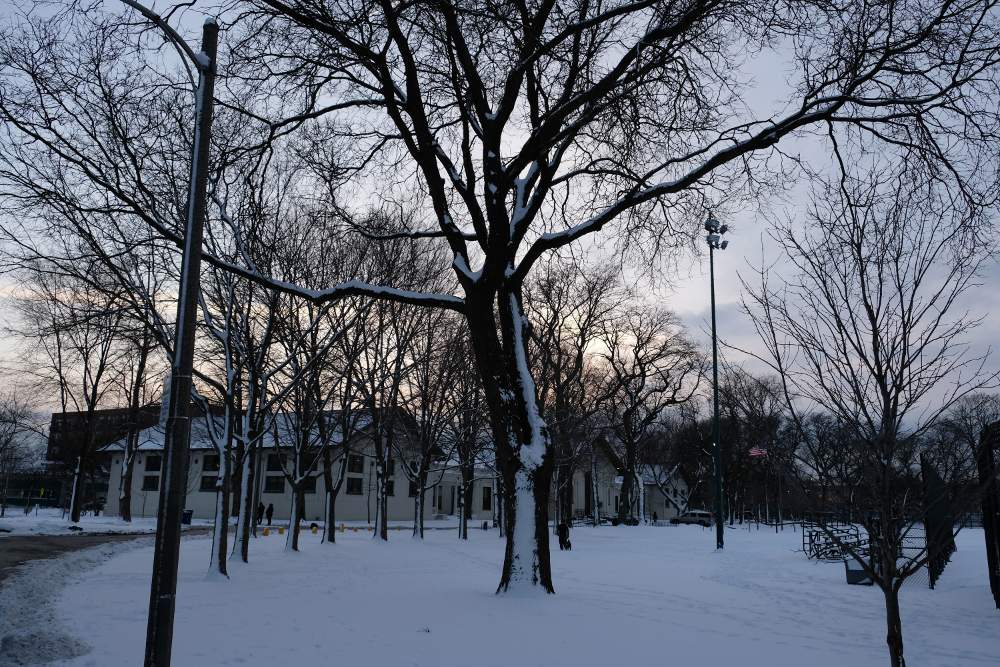 The winter sun sets over the field house in Chicago's McKinley Park.
