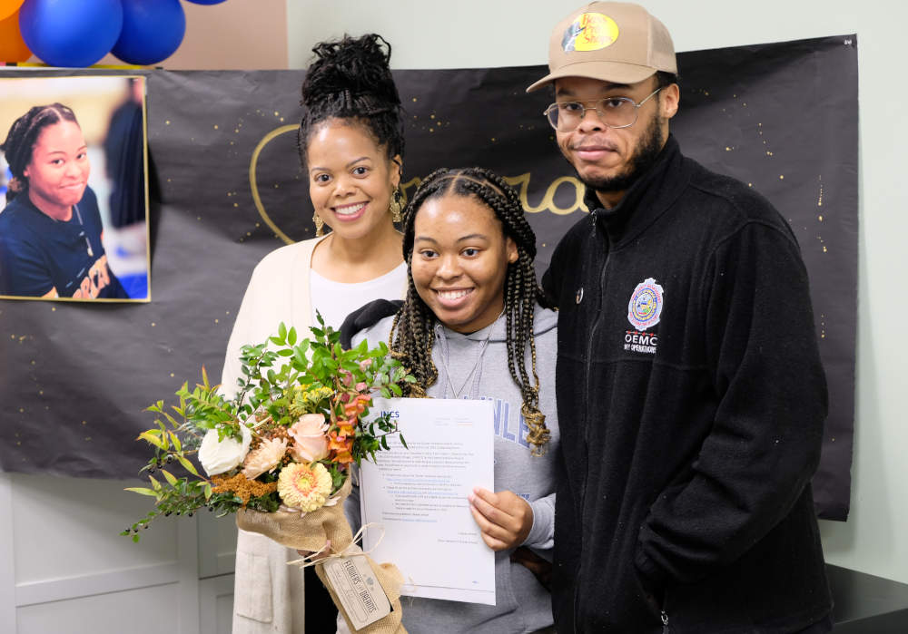 Havilyn Aitken, center, celebrates receiving the INCS Charter School Excellence Award alongside family members at Horizon Science Academy - McKinley Park.