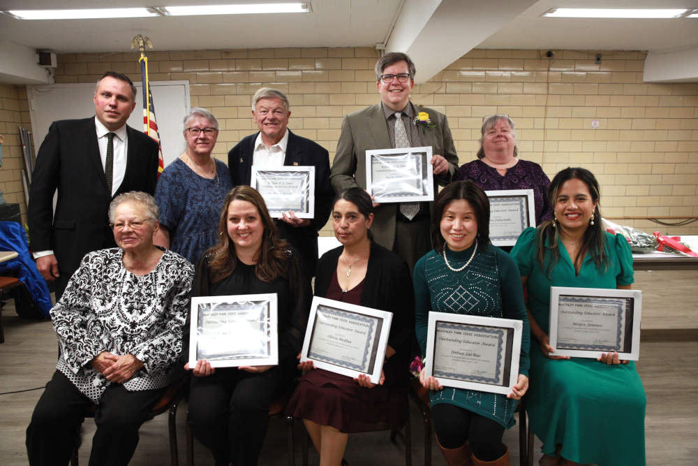 Officers of the McKinley Park Civic Association and winners of the Educator of the Year and William H. Toms Community Service awards celebrate at the association's banquet on Sunday, April 21, 2024.