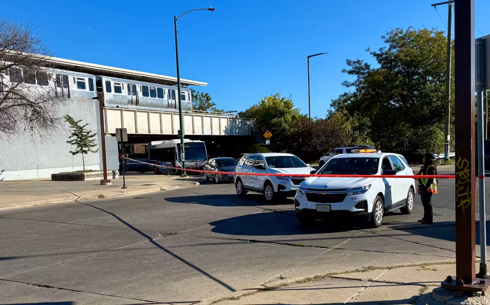 Public safety officers manage the cordon for the homicide investigation at the 35th/Archer Orange Line El station on the morning of the shooting.