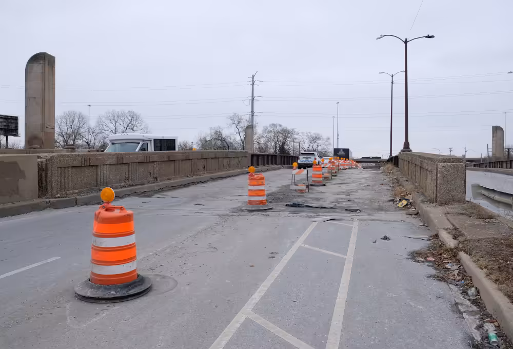 Traffic barrels and poor conditions limit drivers to one lane and bikers without a bike lane on the southbound bridge on South Western Avenue.