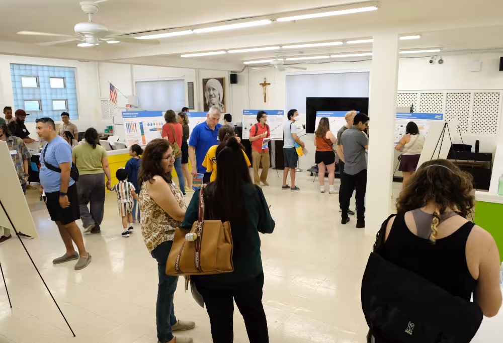 Attendees review panels of the Moving Archer Forward plan on July 8, 2026, at the open house at St. Mother Teresa Hall in the Bridgeport neighborhood.