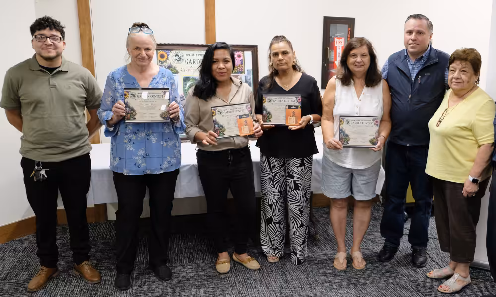 Winning gardeners hold their plaques alongside civic association officers at the first annual gardening contest awards on Wednesday, September 2, 2026.